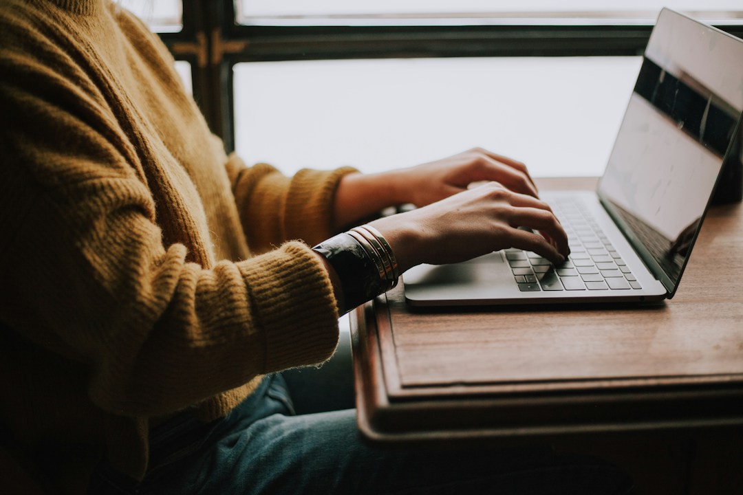 Person typing and editing a document on a laptop