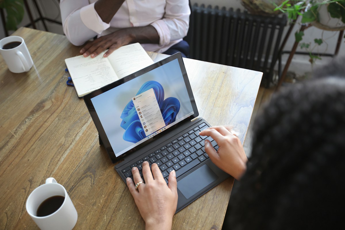 People using a Microsoft laptop for work and productivity