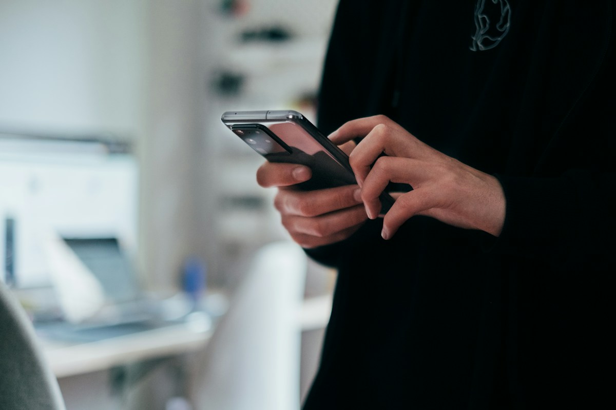 Person using a smartphone for an AI chat