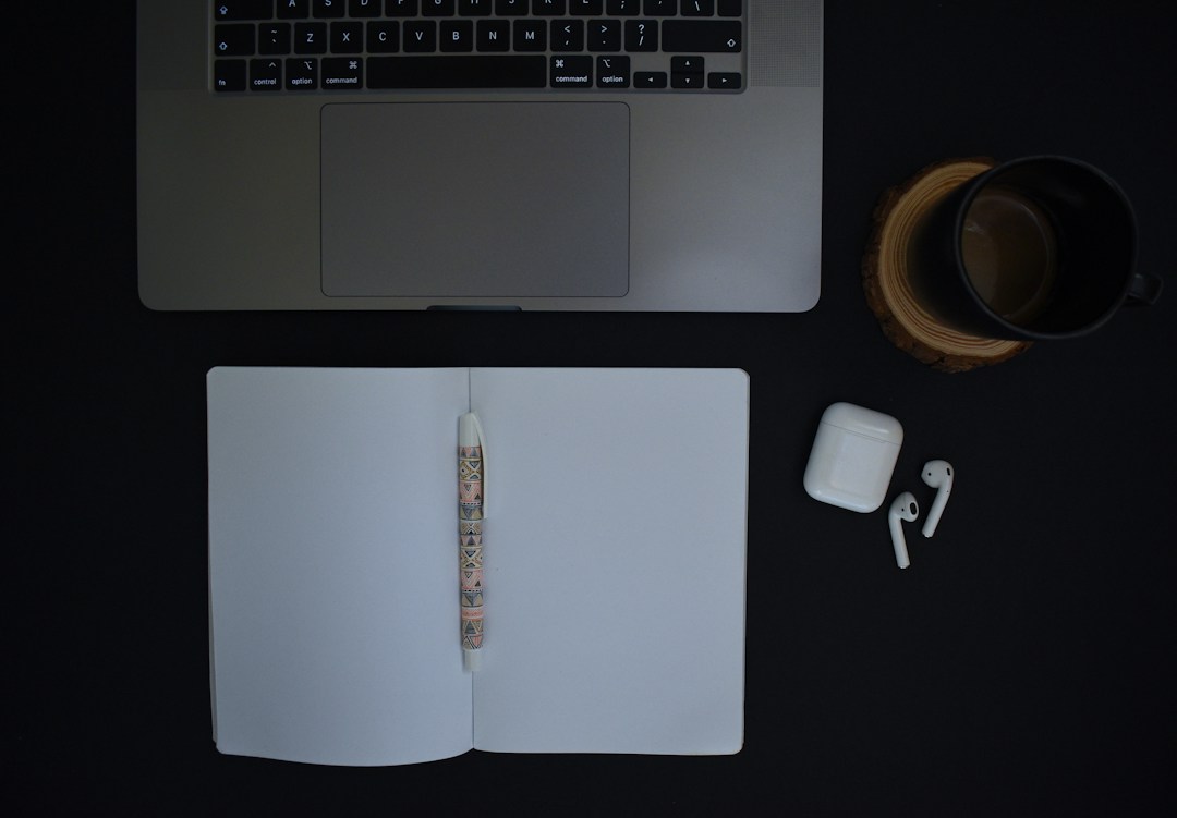 Open notebook and laptop on a desk while planning a story