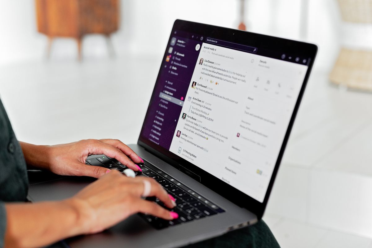Woman typing on a laptop in a modern office