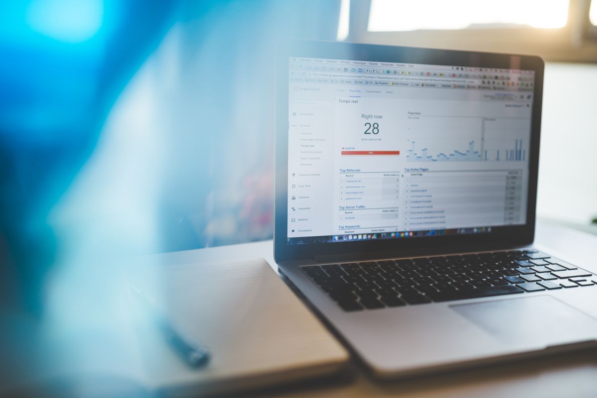 Laptop showing live website analytics on a desk
