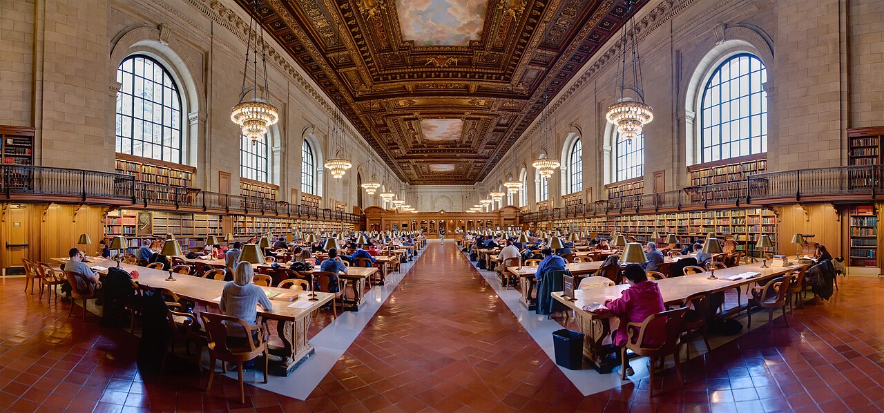A grand university library research reading room with long wooden tables