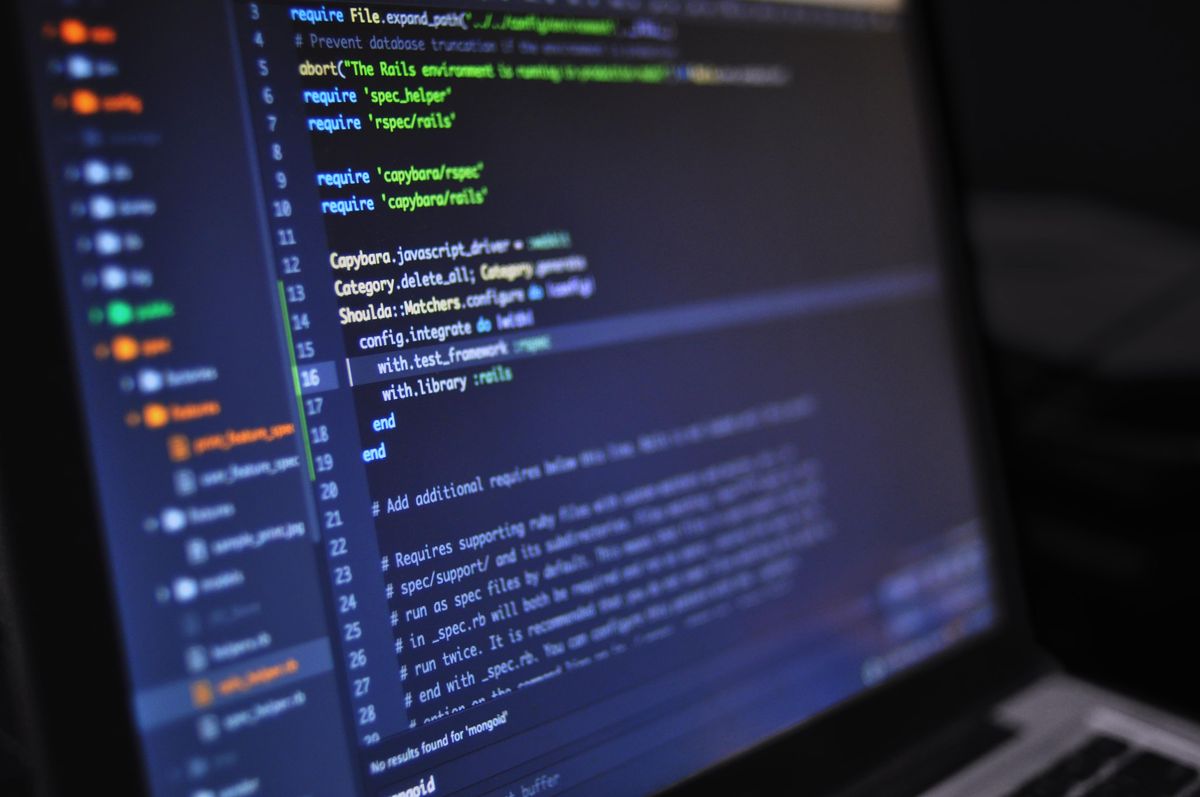Laptop showing code on screen during a website update